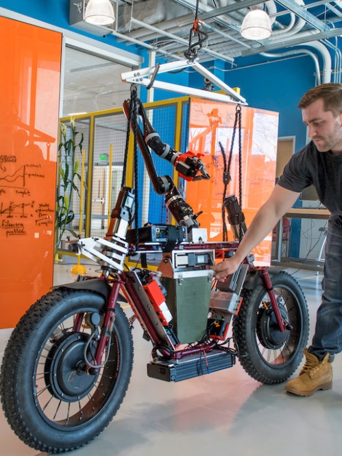 Person looking at a prototype of a self-driving motorcycle