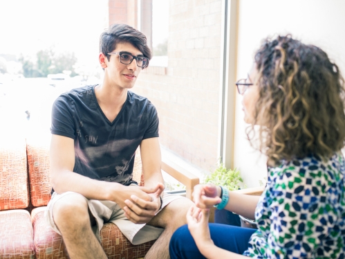 male student being advised by female counselor